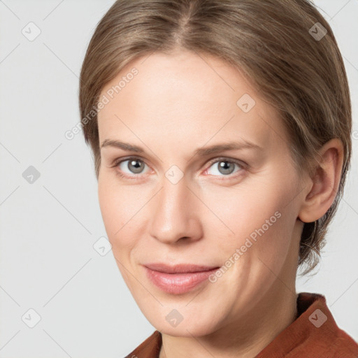 Joyful white young-adult female with medium  brown hair and blue eyes