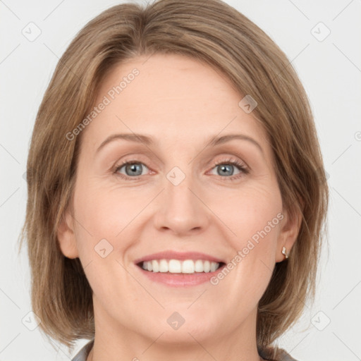 Joyful white adult female with medium  brown hair and green eyes