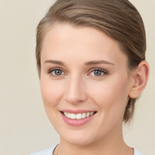 Joyful white young-adult female with medium  brown hair and grey eyes