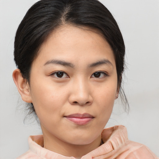 Joyful asian young-adult female with medium  brown hair and brown eyes