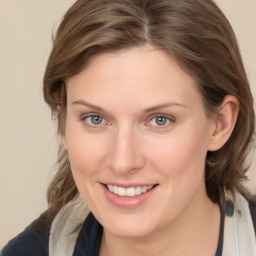 Joyful white young-adult female with medium  brown hair and blue eyes