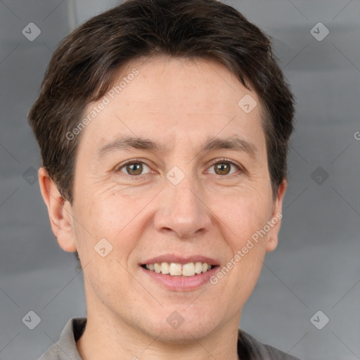 Joyful white adult male with short  brown hair and brown eyes