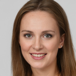 Joyful white young-adult female with long  brown hair and grey eyes