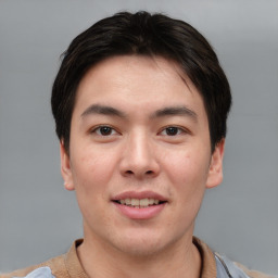 Joyful asian young-adult male with short  brown hair and brown eyes