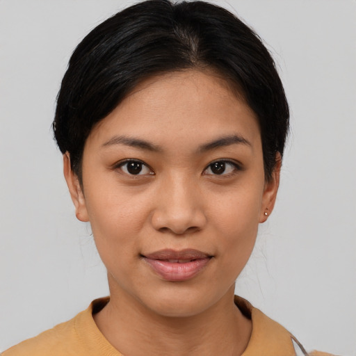 Joyful latino young-adult female with short  brown hair and brown eyes