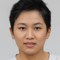 Joyful asian young-adult female with short  brown hair and brown eyes