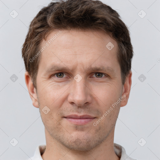 Joyful white adult male with short  brown hair and grey eyes