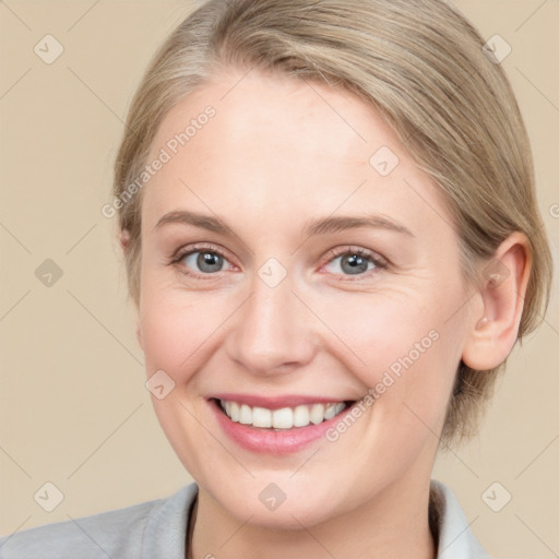 Joyful white adult female with medium  brown hair and blue eyes