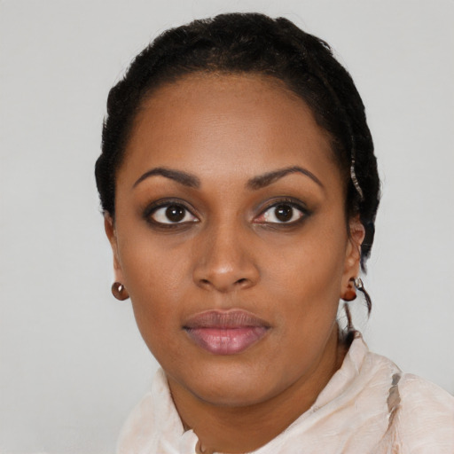 Joyful black young-adult female with short  black hair and brown eyes