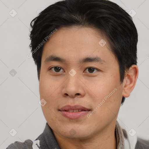 Joyful asian young-adult male with short  brown hair and brown eyes