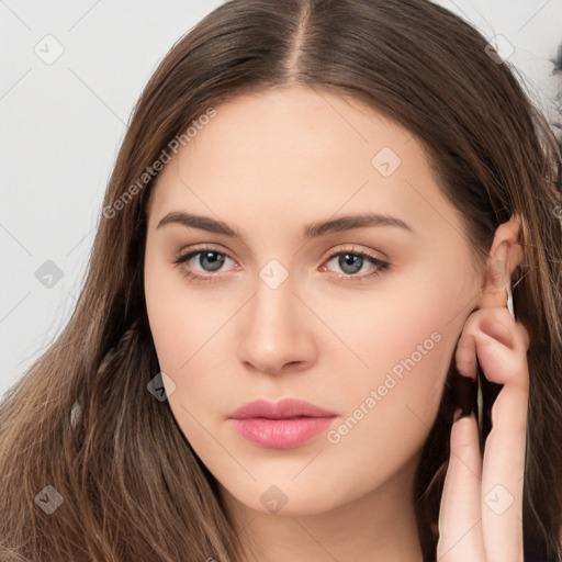 Neutral white young-adult female with long  brown hair and brown eyes