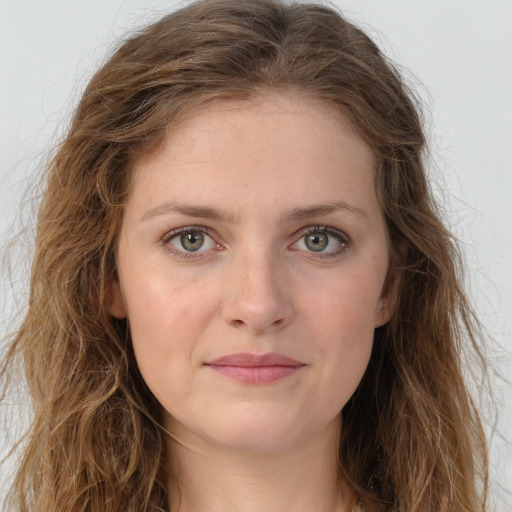 Joyful white young-adult female with long  brown hair and green eyes