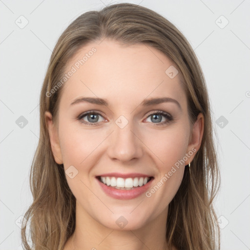 Joyful white young-adult female with long  brown hair and blue eyes