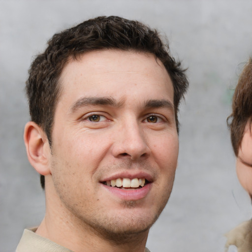 Joyful white young-adult male with short  brown hair and brown eyes