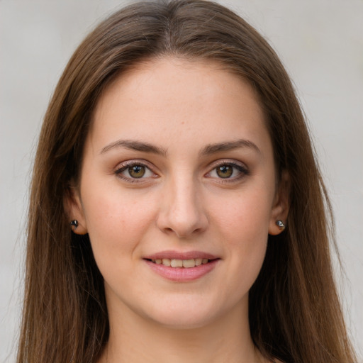 Joyful white young-adult female with long  brown hair and green eyes