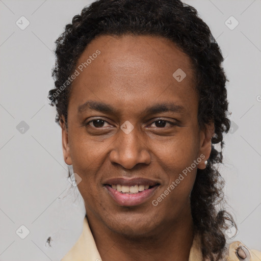 Joyful black young-adult male with short  brown hair and brown eyes