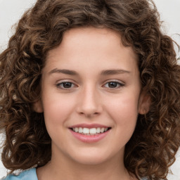 Joyful white child female with long  brown hair and brown eyes