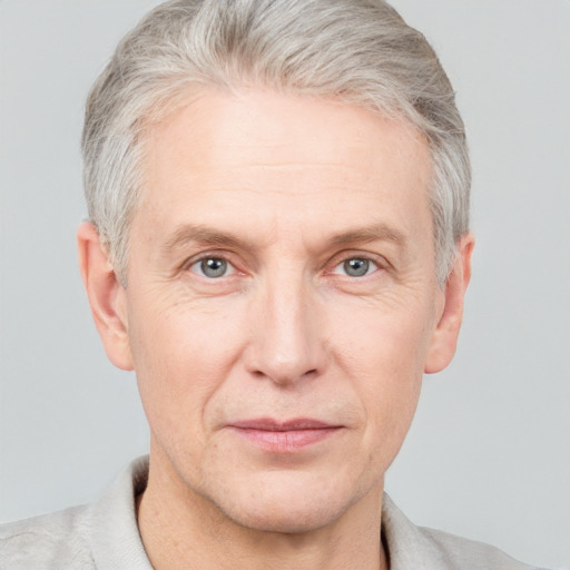 Joyful white middle-aged male with short  gray hair and grey eyes