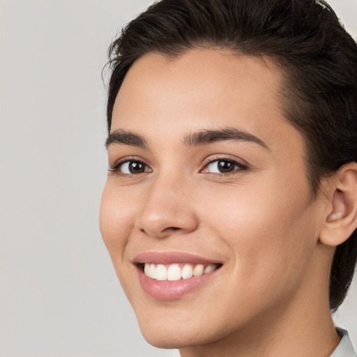 Joyful white young-adult female with short  brown hair and brown eyes