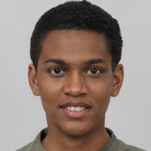 Joyful black young-adult male with short  black hair and brown eyes