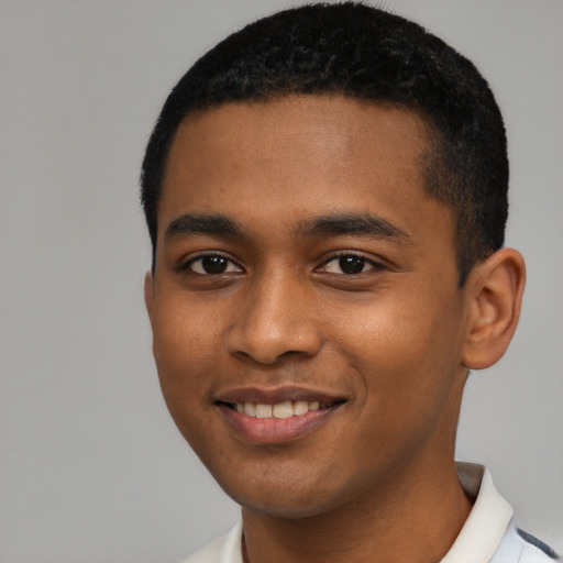 Joyful black young-adult male with short  black hair and brown eyes