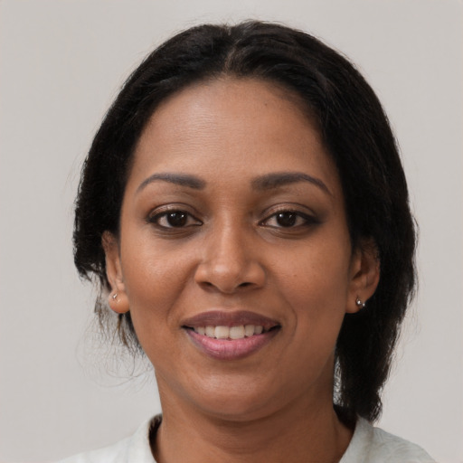 Joyful black adult female with medium  black hair and brown eyes