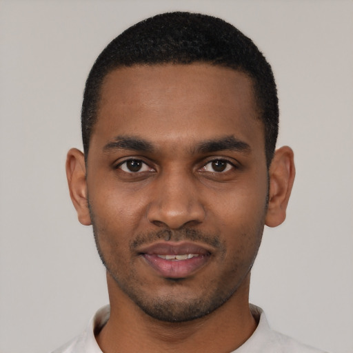 Joyful black young-adult male with short  black hair and brown eyes