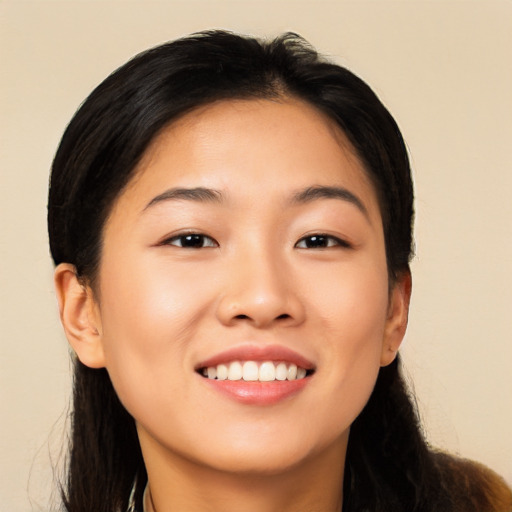 Joyful asian young-adult female with long  brown hair and brown eyes