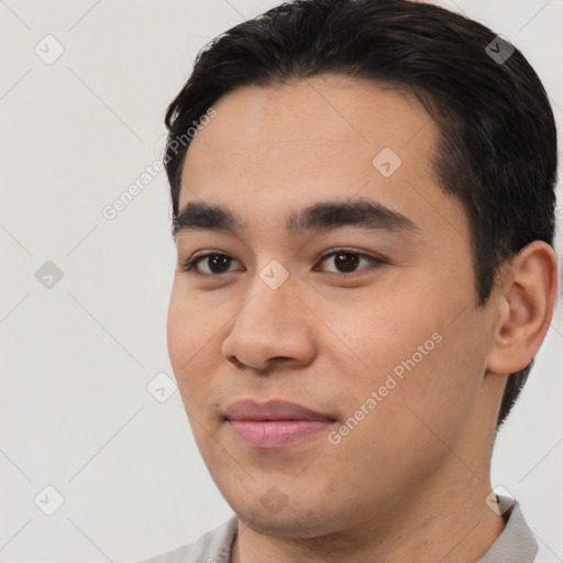 Joyful white young-adult male with short  black hair and brown eyes