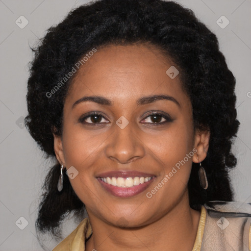 Joyful black young-adult female with long  black hair and brown eyes