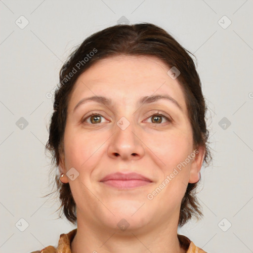 Joyful white adult female with medium  brown hair and brown eyes