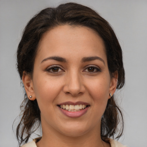 Joyful white young-adult female with medium  brown hair and brown eyes