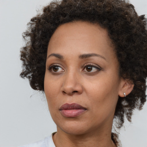 Neutral black adult female with medium  brown hair and brown eyes