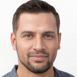 Joyful white young-adult male with short  brown hair and brown eyes