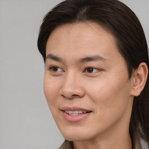 Joyful asian young-adult female with short  brown hair and brown eyes