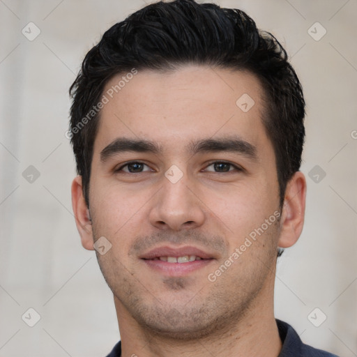 Joyful white young-adult male with short  black hair and brown eyes