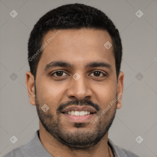 Joyful black young-adult male with short  black hair and brown eyes