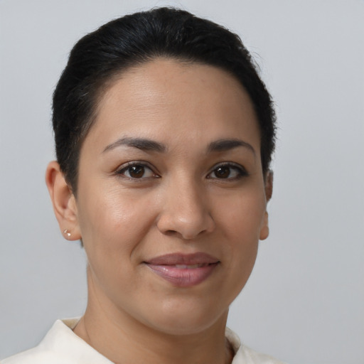Joyful latino young-adult female with short  brown hair and brown eyes