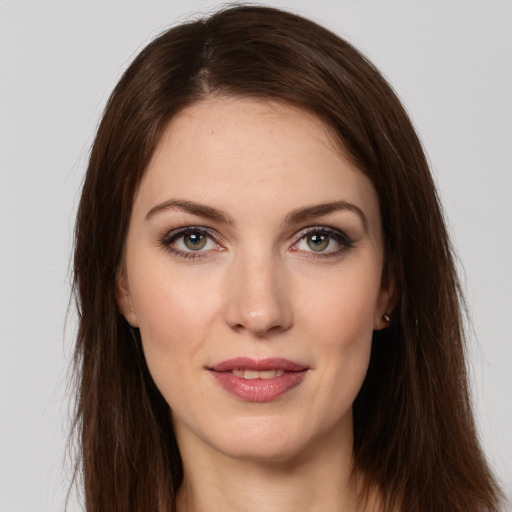 Joyful white young-adult female with long  brown hair and grey eyes