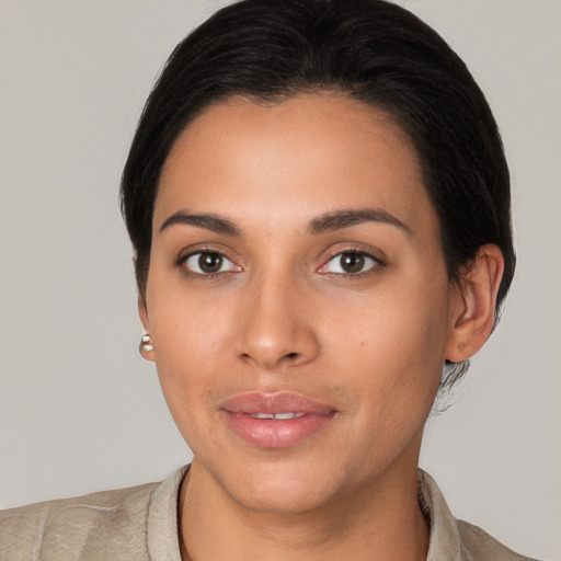 Joyful latino young-adult female with short  brown hair and brown eyes