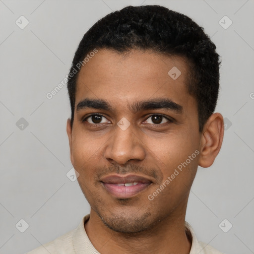 Joyful black young-adult male with short  black hair and brown eyes