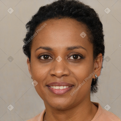 Joyful black young-adult female with short  brown hair and brown eyes