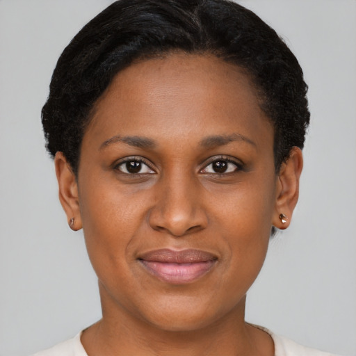 Joyful black young-adult female with short  brown hair and brown eyes