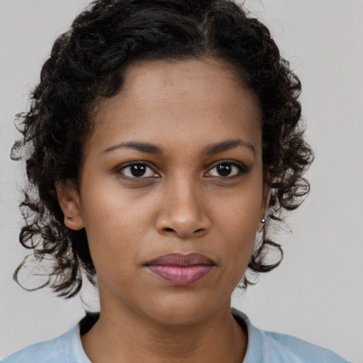 Neutral black young-adult female with medium  brown hair and brown eyes