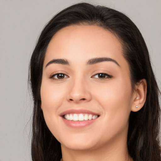 Joyful white young-adult female with long  brown hair and brown eyes