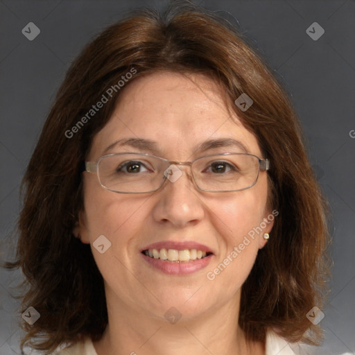 Joyful white adult female with medium  brown hair and blue eyes