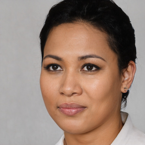 Joyful latino young-adult female with short  black hair and brown eyes