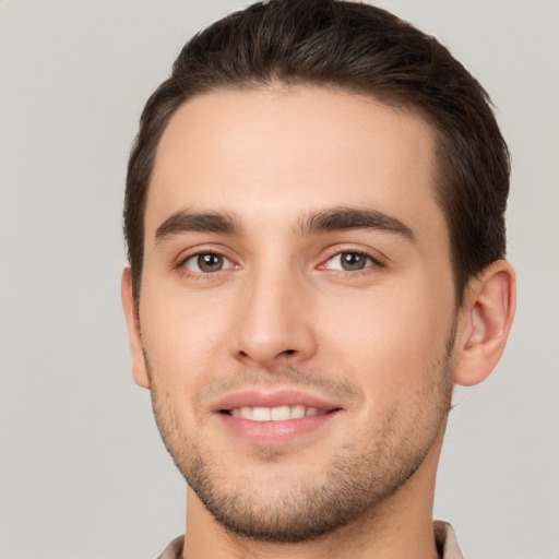 Joyful white young-adult male with short  brown hair and brown eyes