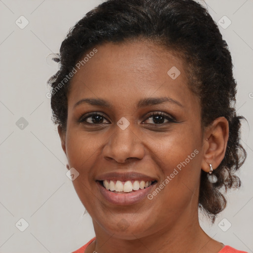 Joyful black young-adult female with short  brown hair and brown eyes