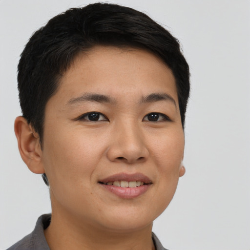 Joyful asian young-adult female with short  brown hair and brown eyes
